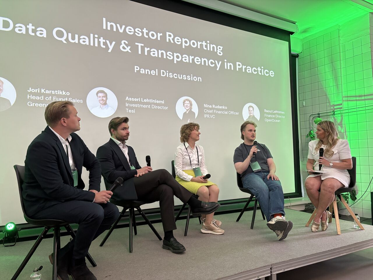 Panel discussion at Greenstep's investor reporting event in Helsinki, May 2026. Five panellists seated on stage in front of a projected slide reading 